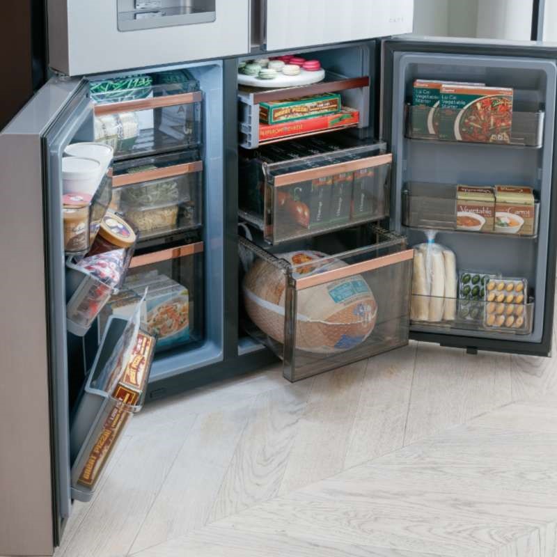 Bottom freezer doors open on Cafe's Glass french door refrigerator